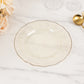 Gold glitter plastic dinner plate with ruffled rim on a marble surface.
