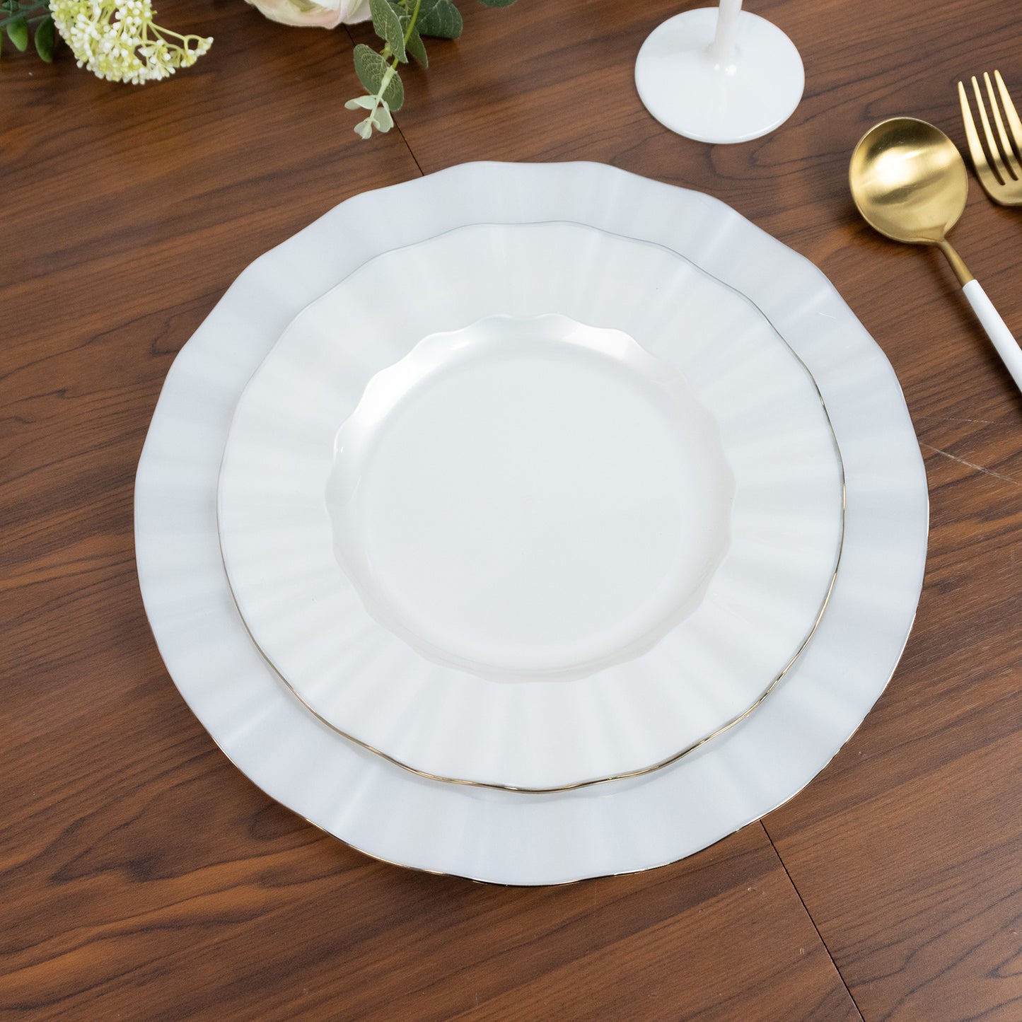 Pearl white ruffled rim dinner plates with gold edging.