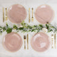 Dusty rose swirl plastic dinner plates with gold rim, elegant party table setting.