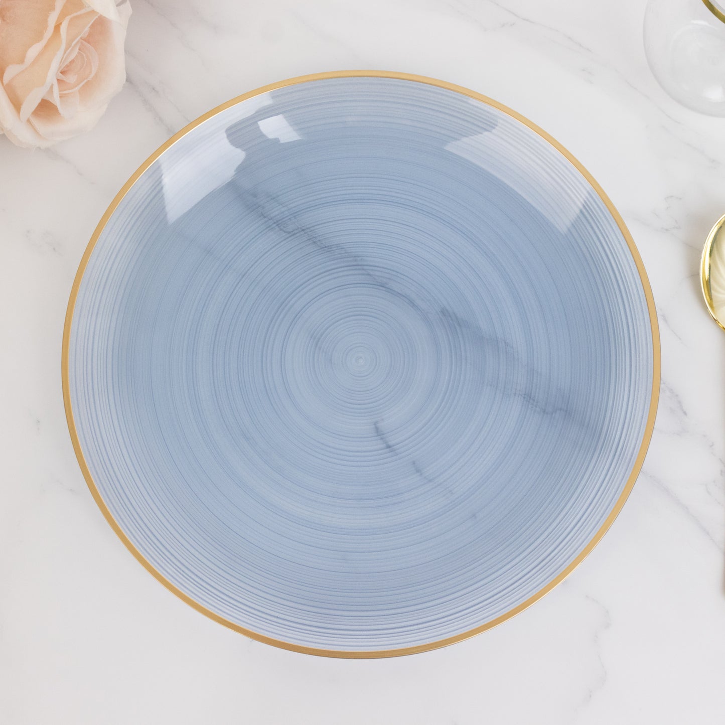 Transparent dusty blue swirl plate with gold rim.