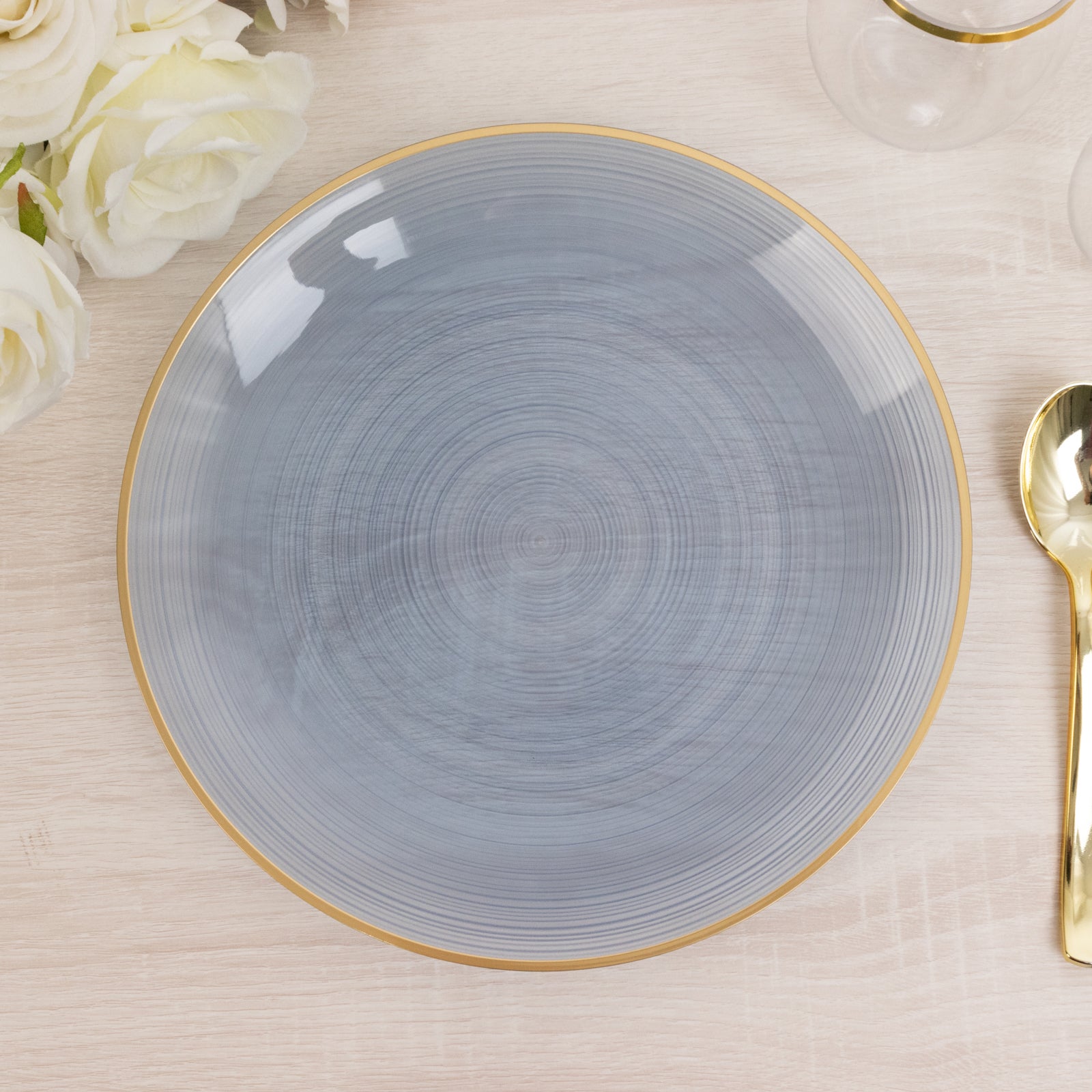 Transparent dusty blue swirl plate with gold rim, elegant for parties.