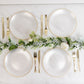 Transparent pearl white swirl dinner plates with gold rim.