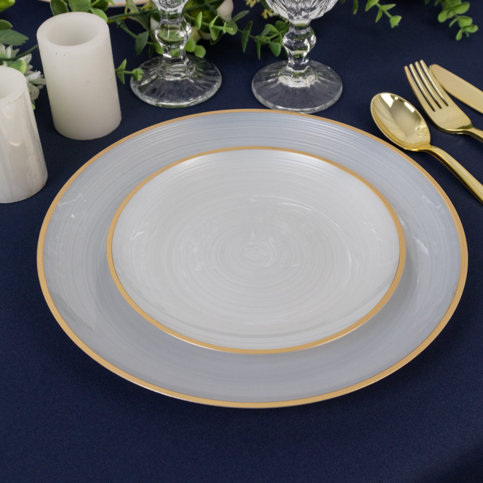 Transparent pearl white swirl dinner plates with gold rim.