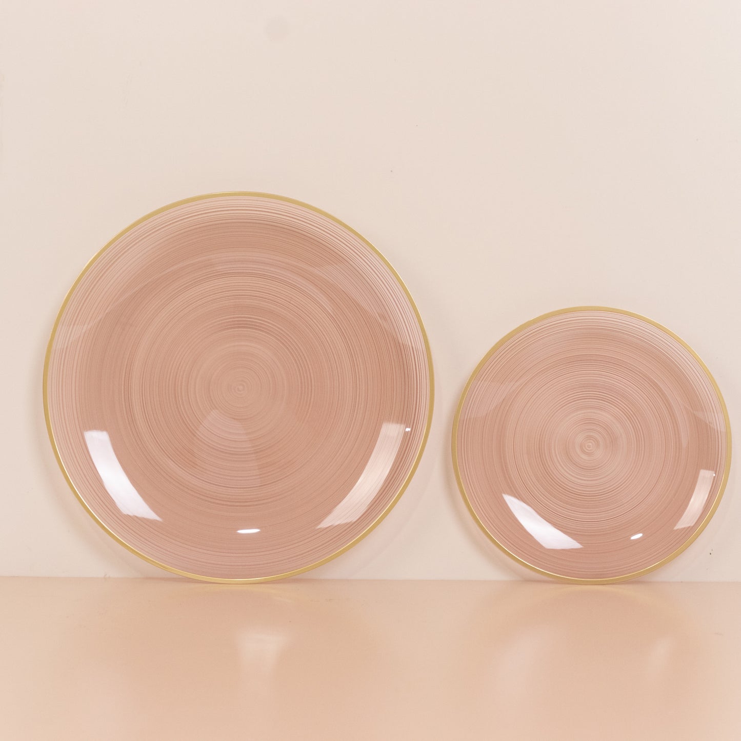 Dusty rose swirl plastic plates with gold rim, elegant party dinnerware.