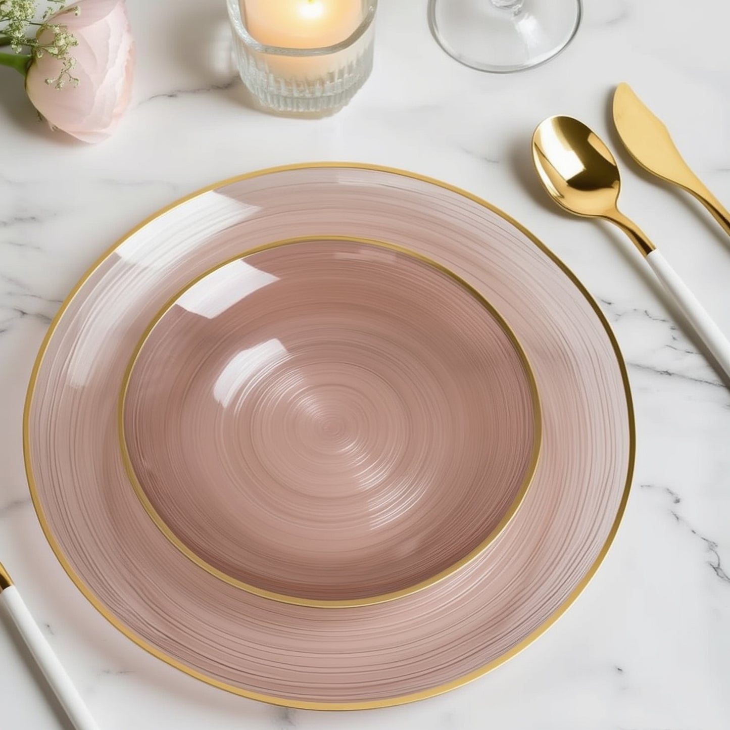 Dusty rose swirl plastic salad plates with gold rim on a marble surface.