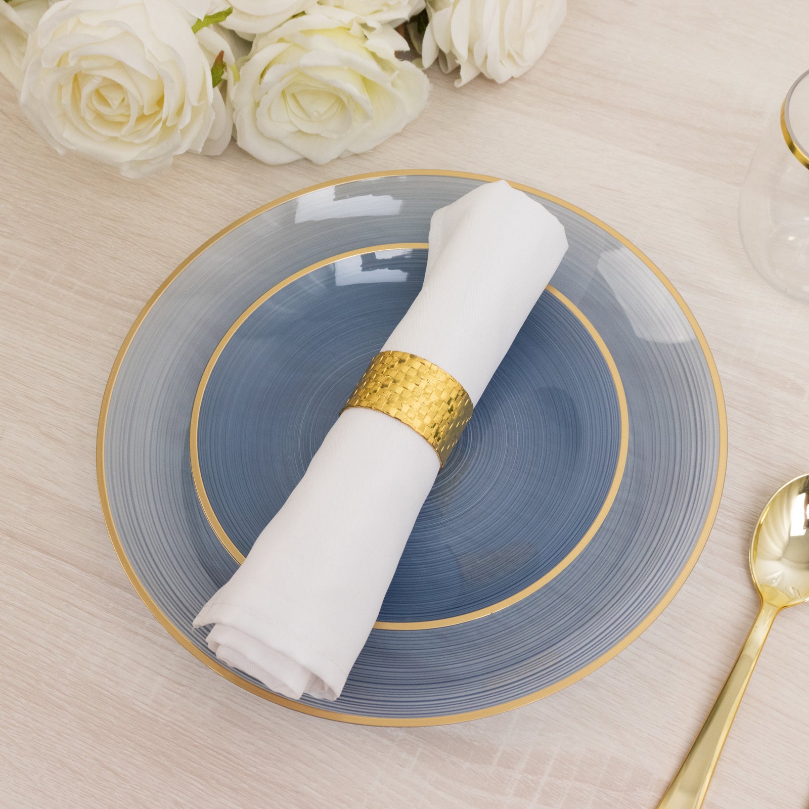 7" round transparent dusty blue swirl plate with gold rim and white napkin.