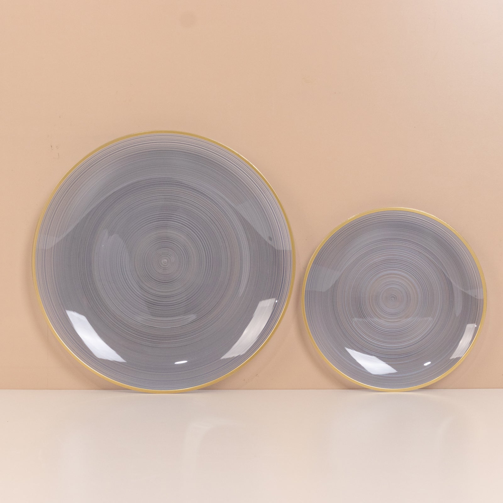 Dusty blue swirl plastic salad dessert plates with gold rim.