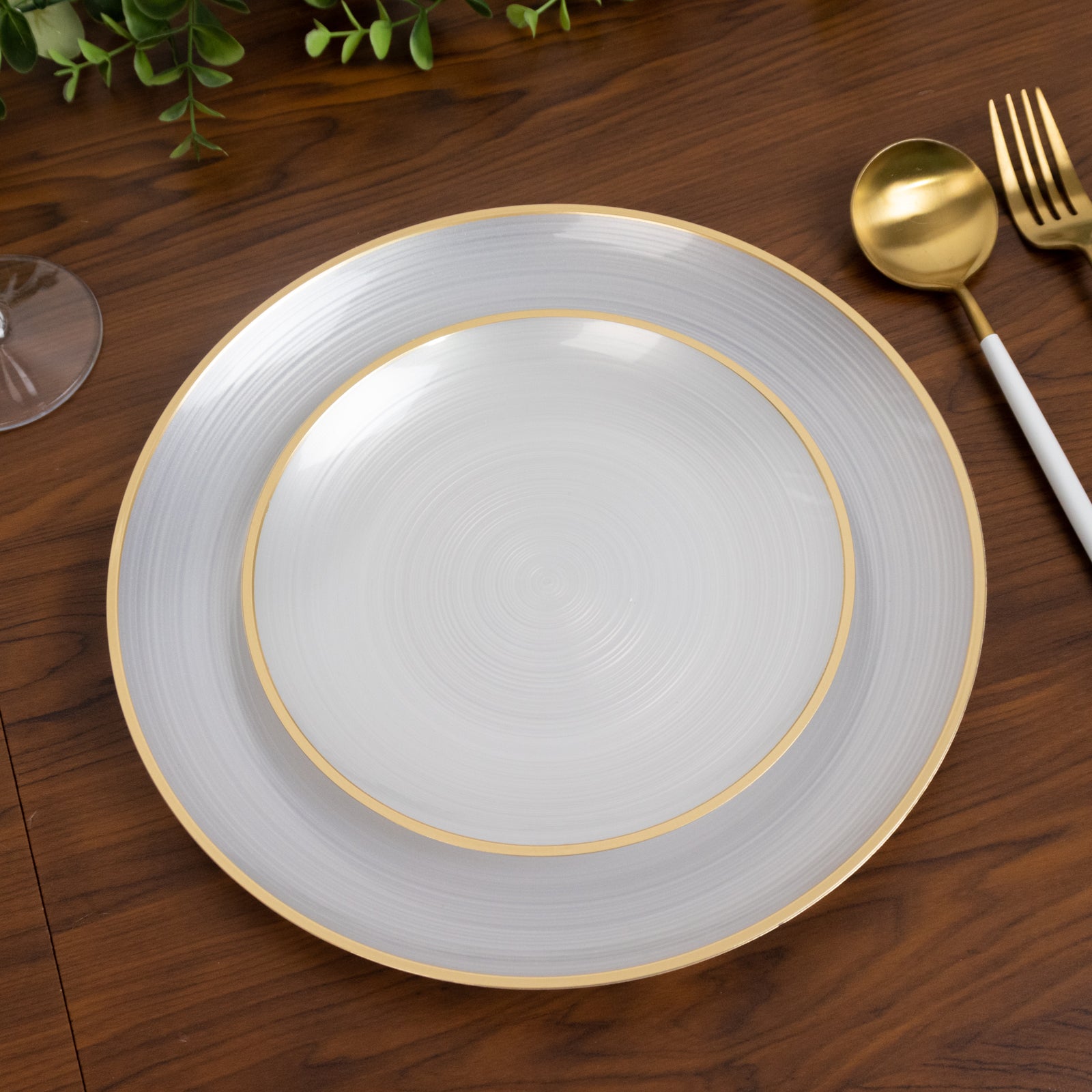 Transparent pearl white swirl plates with gold rim, elegant for parties.