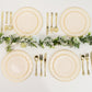 Ivory and gold disposable dessert plates arranged elegantly on a table.