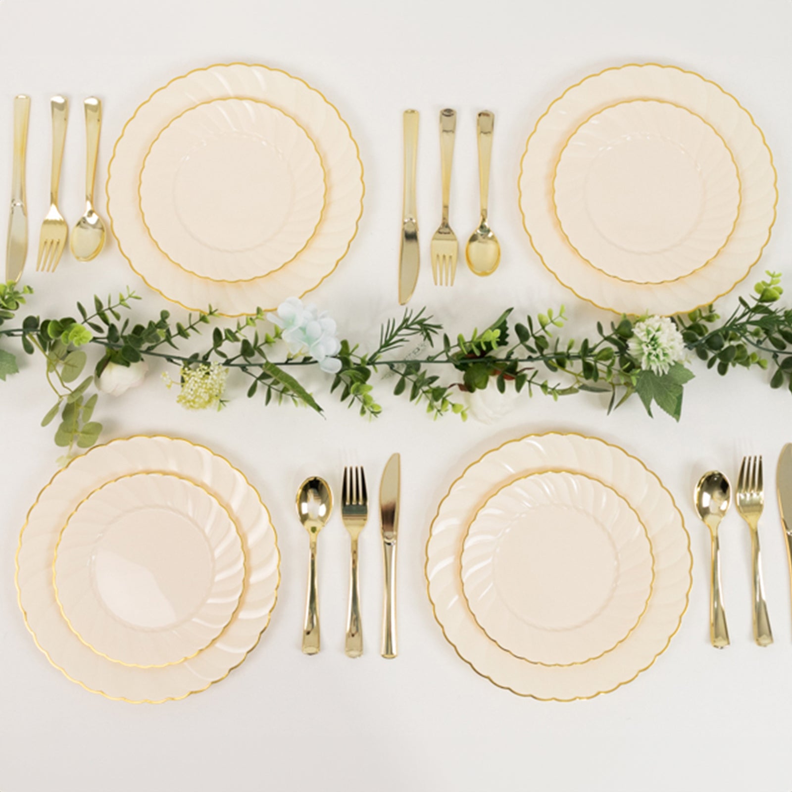 Ivory and gold disposable dessert plates arranged elegantly on a table.