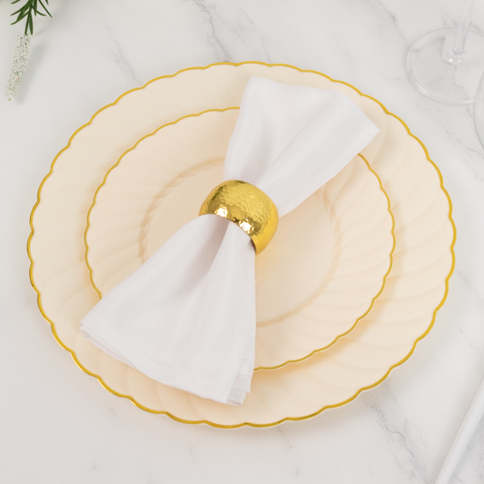 Ivory and gold flair rim plastic dessert plates with napkin.