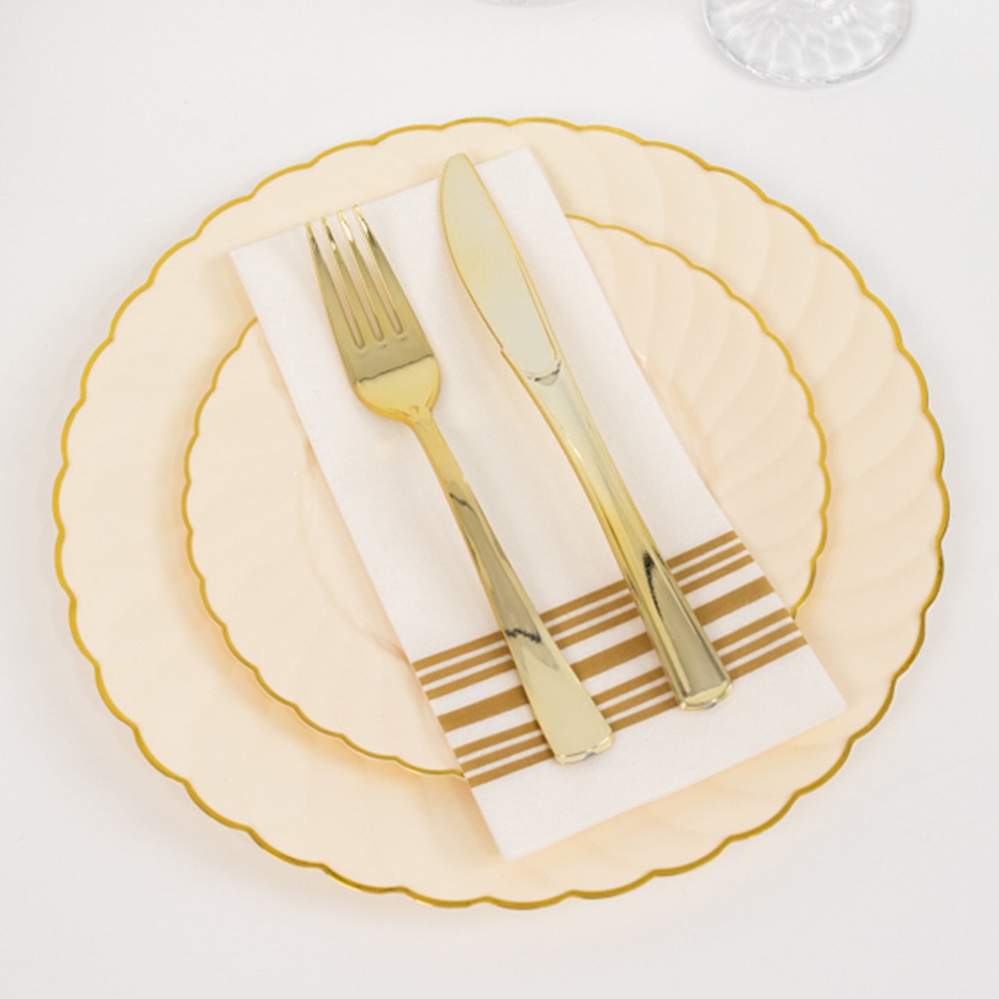 Ivory and gold disposable dessert appetizer plates with cutlery.