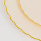 Ivory and gold flair rim disposable dessert plates stacked.
