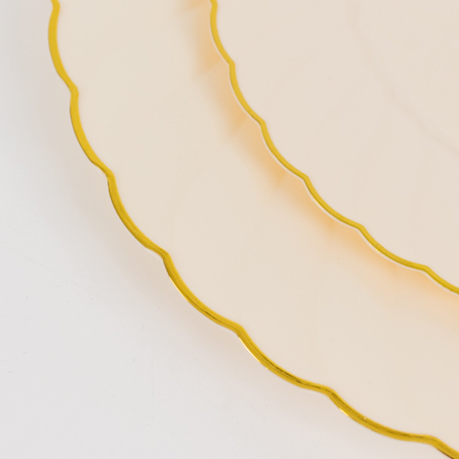 Ivory and gold flair rim disposable dessert plates stacked.