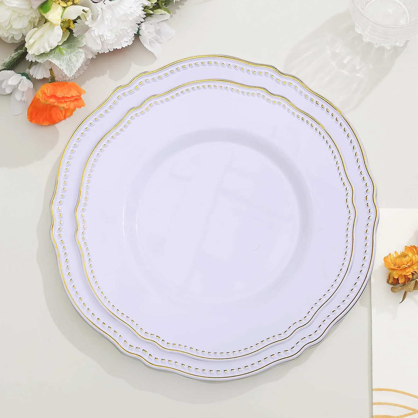 Elegant white plate with gold trim on a decorative table setting.