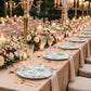 Sage green and white floral disposable dinner plates on elegantly set table.