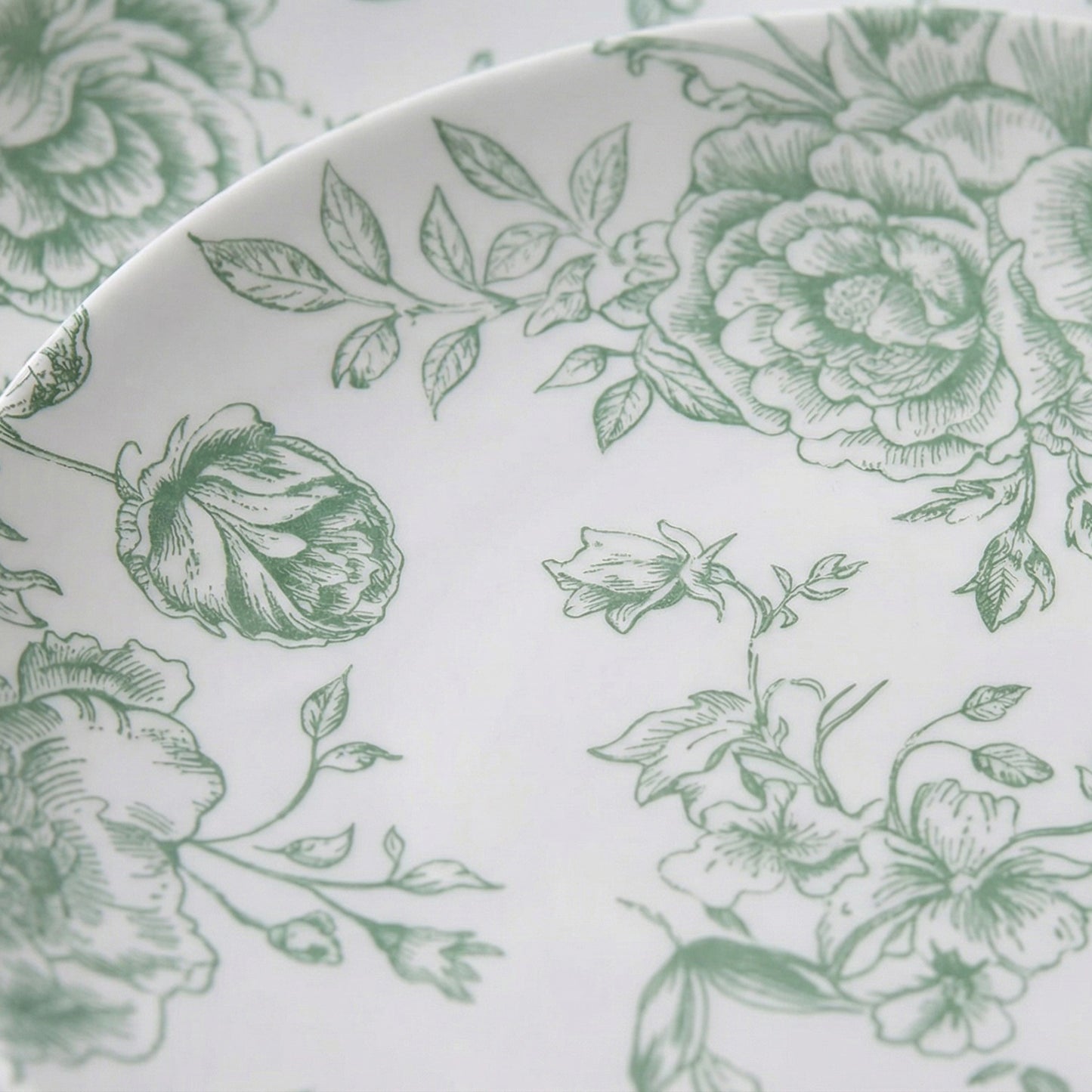 Sage green and white floral disposable party plates.