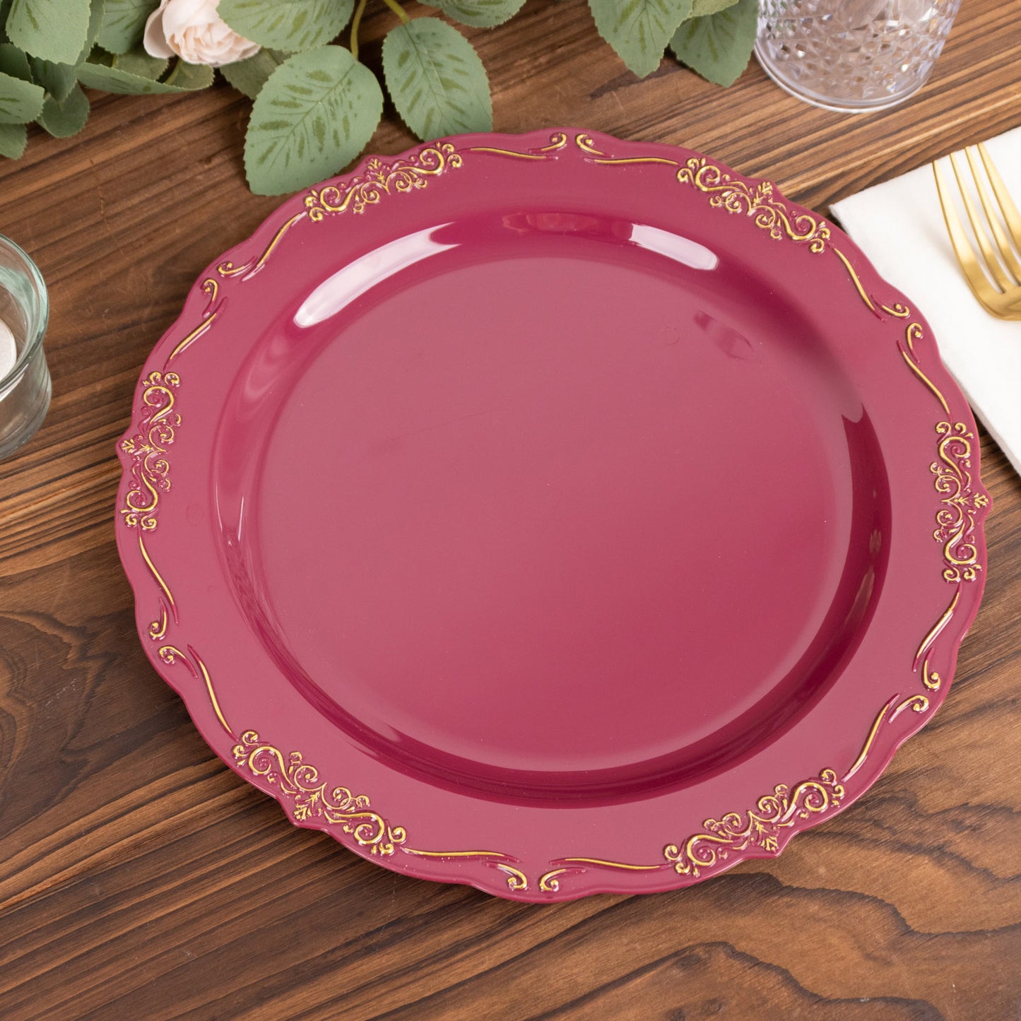 10" burgundy disposable dinner plate with gold vintage rim.