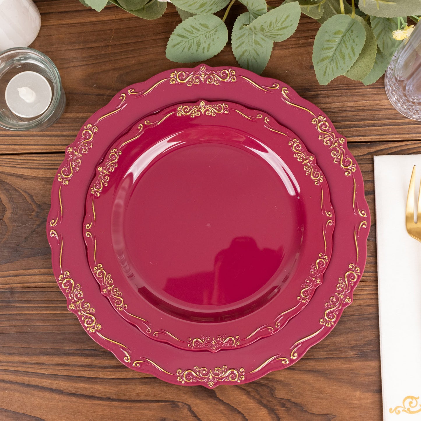 Burgundy disposable dinner plate with gold vintage rim and embossed scalloped edges.