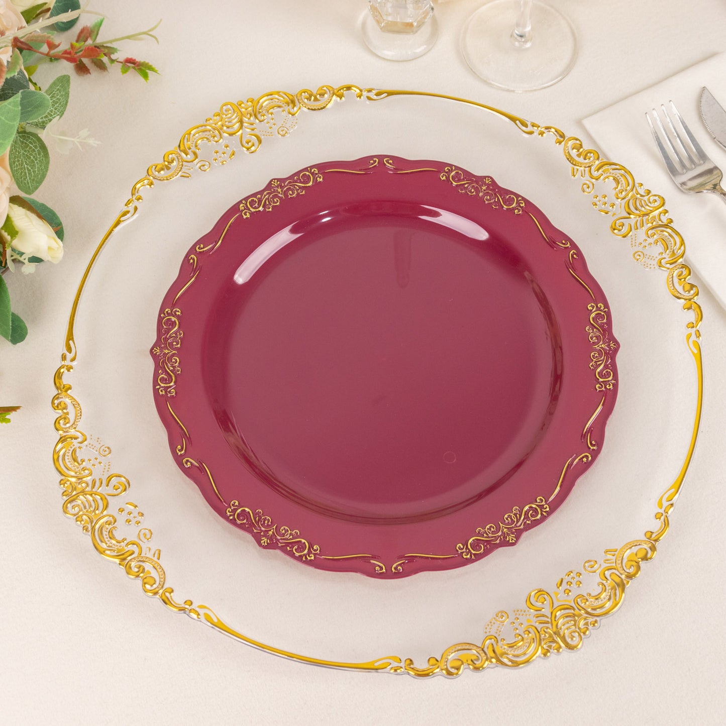 Burgundy disposable dinner plate with gold vintage rim and embossed scalloped edges.