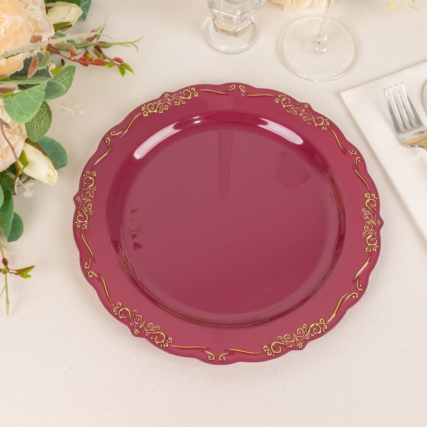Burgundy disposable dinner plate with embossed gold vintage rim.