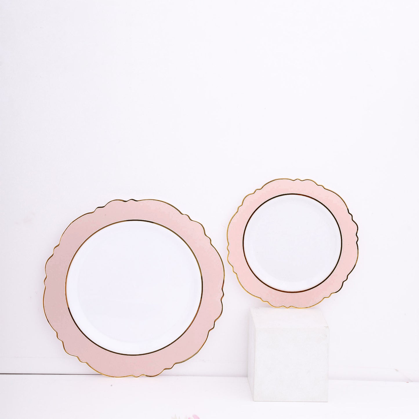 Blush white disposable dinner plates with gold rim and round blossom design.