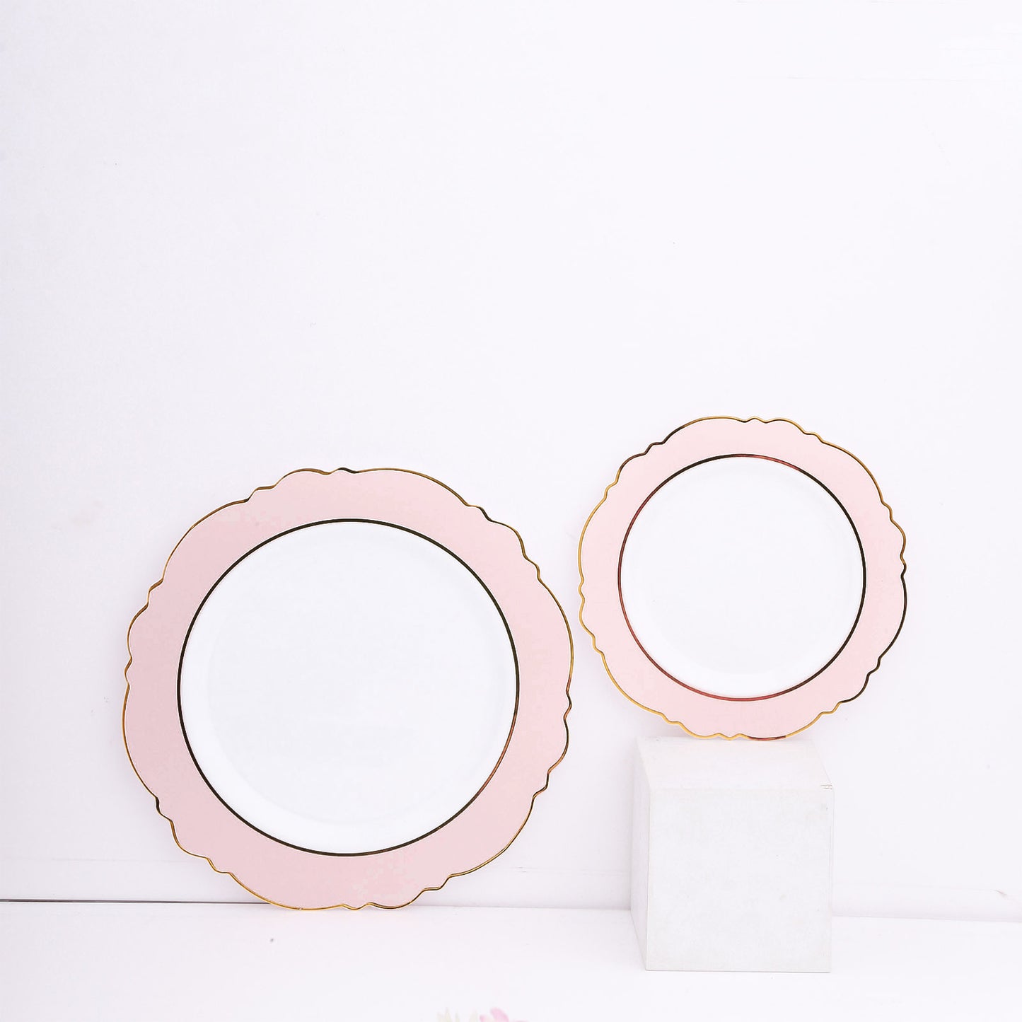 Blush white disposable salad plates with gold rim and round blossom design.