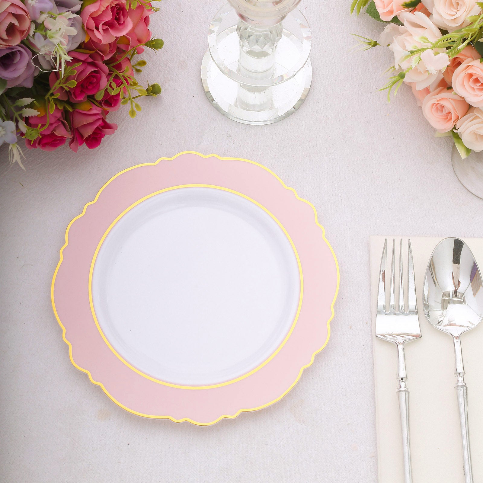 Blush pink disposable salad plate with gold rim and round blossom design.