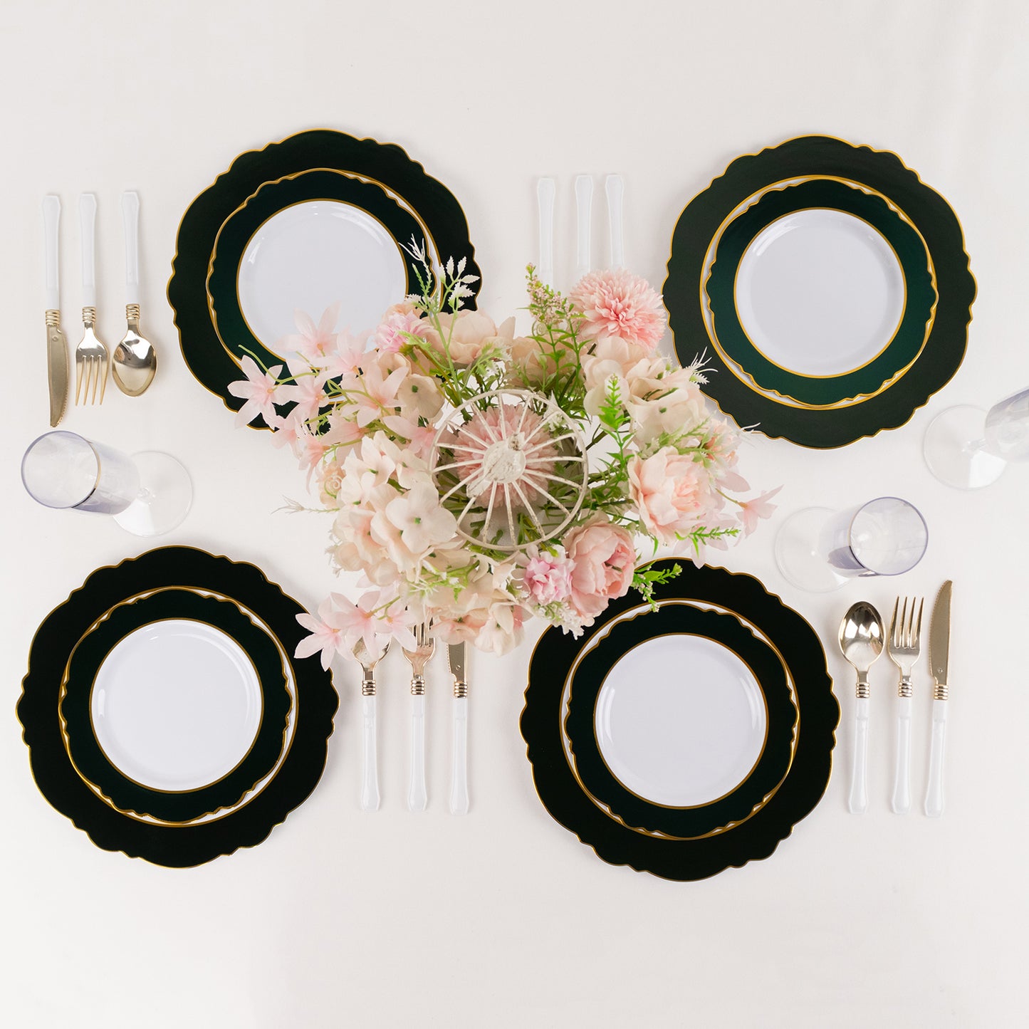 Emerald green disposable salad plates with gold rim and round blossom design.