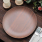 Rustic brown melamine dinner plate on a wooden table with decor.