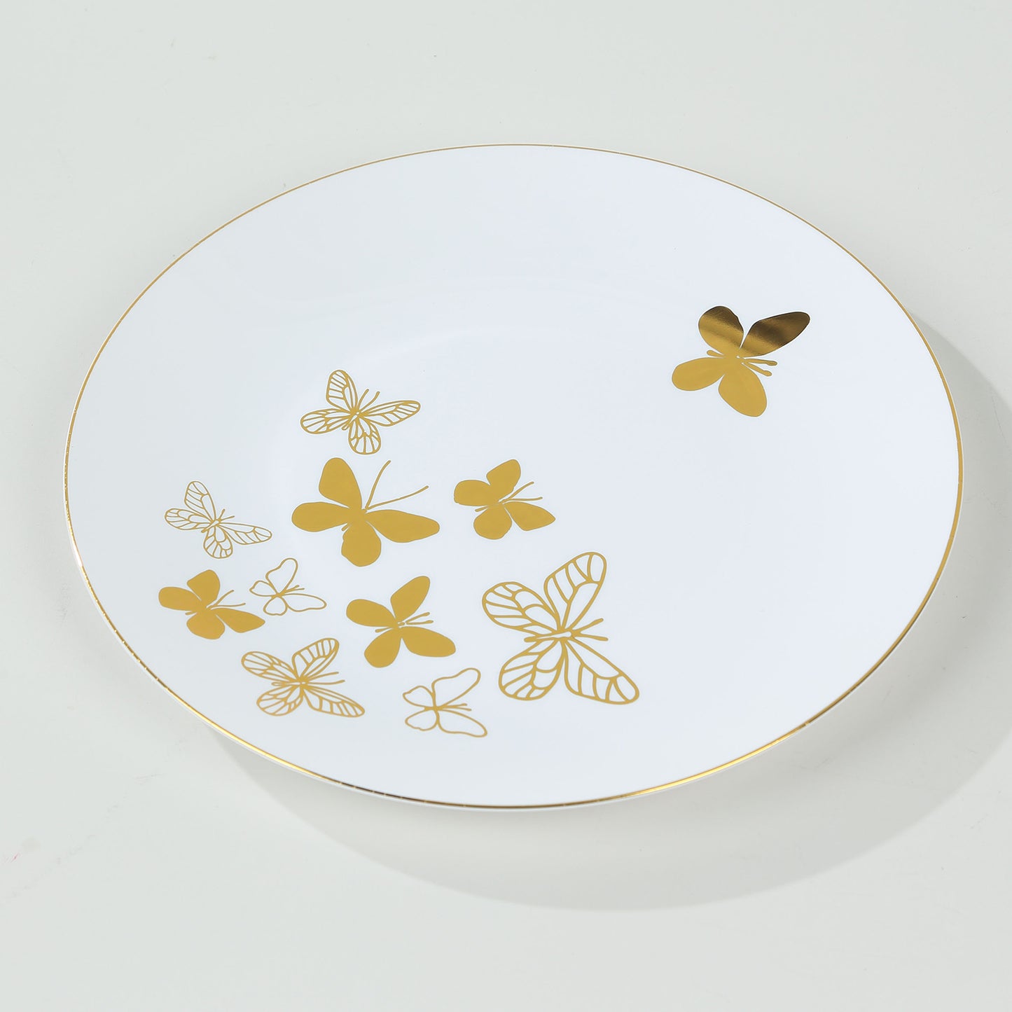 White gold butterfly plastic party plate with gold rim.