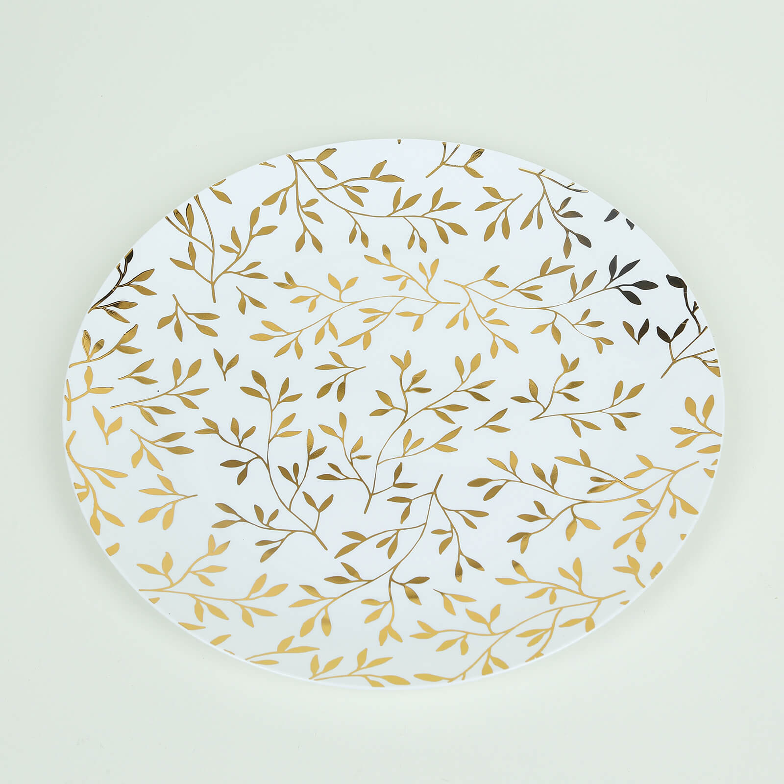 White round plastic party plate with gold leaf design.