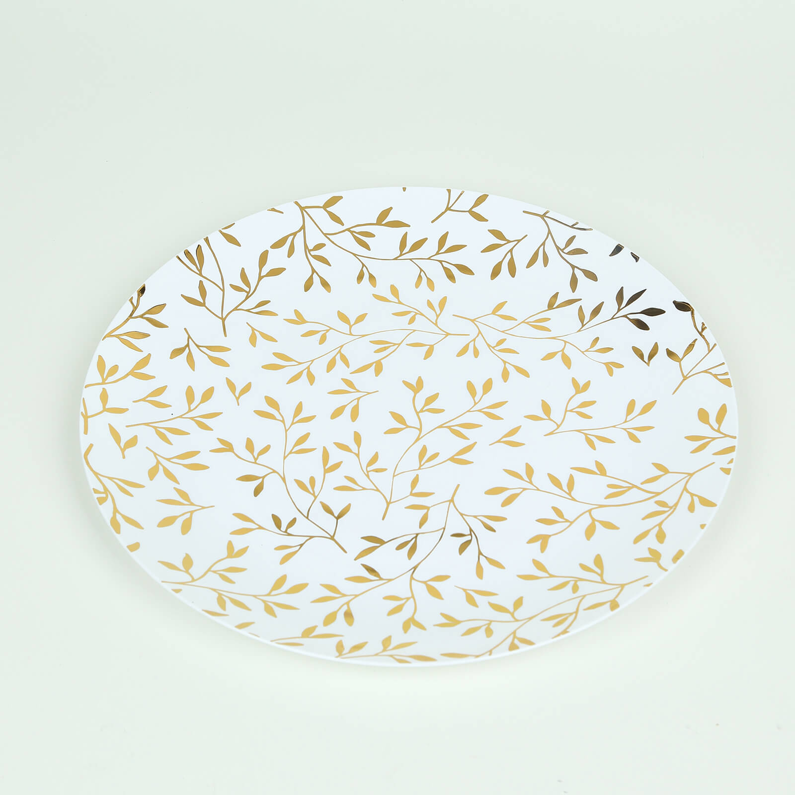 White round plastic party plate with gold leaf design.