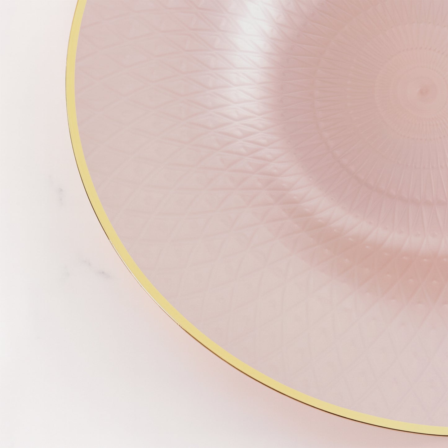 Blush round plastic dinner plate with gold rim and diamond-cut pattern.