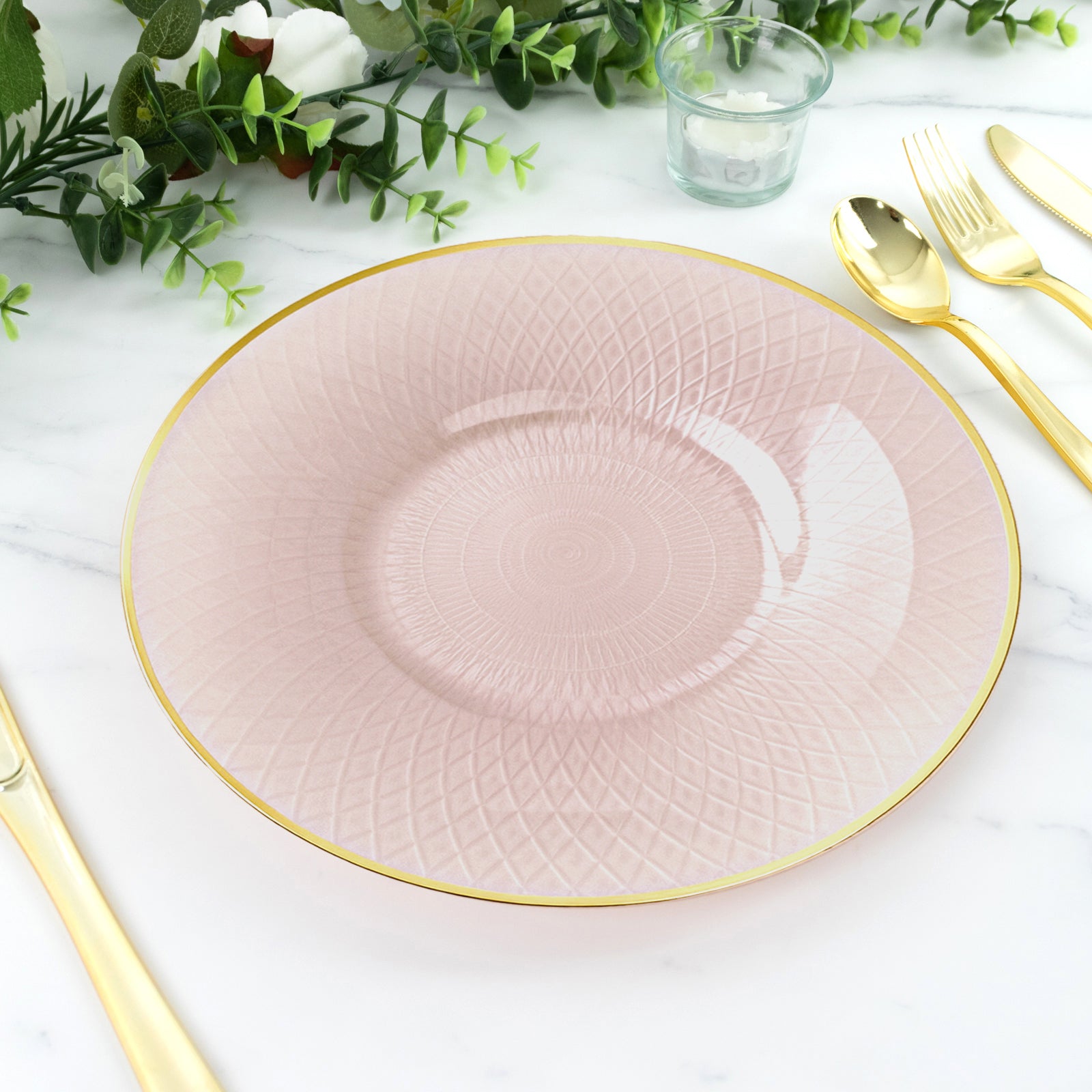 Blush pink round plate with gold rim and diamond-cut pattern.