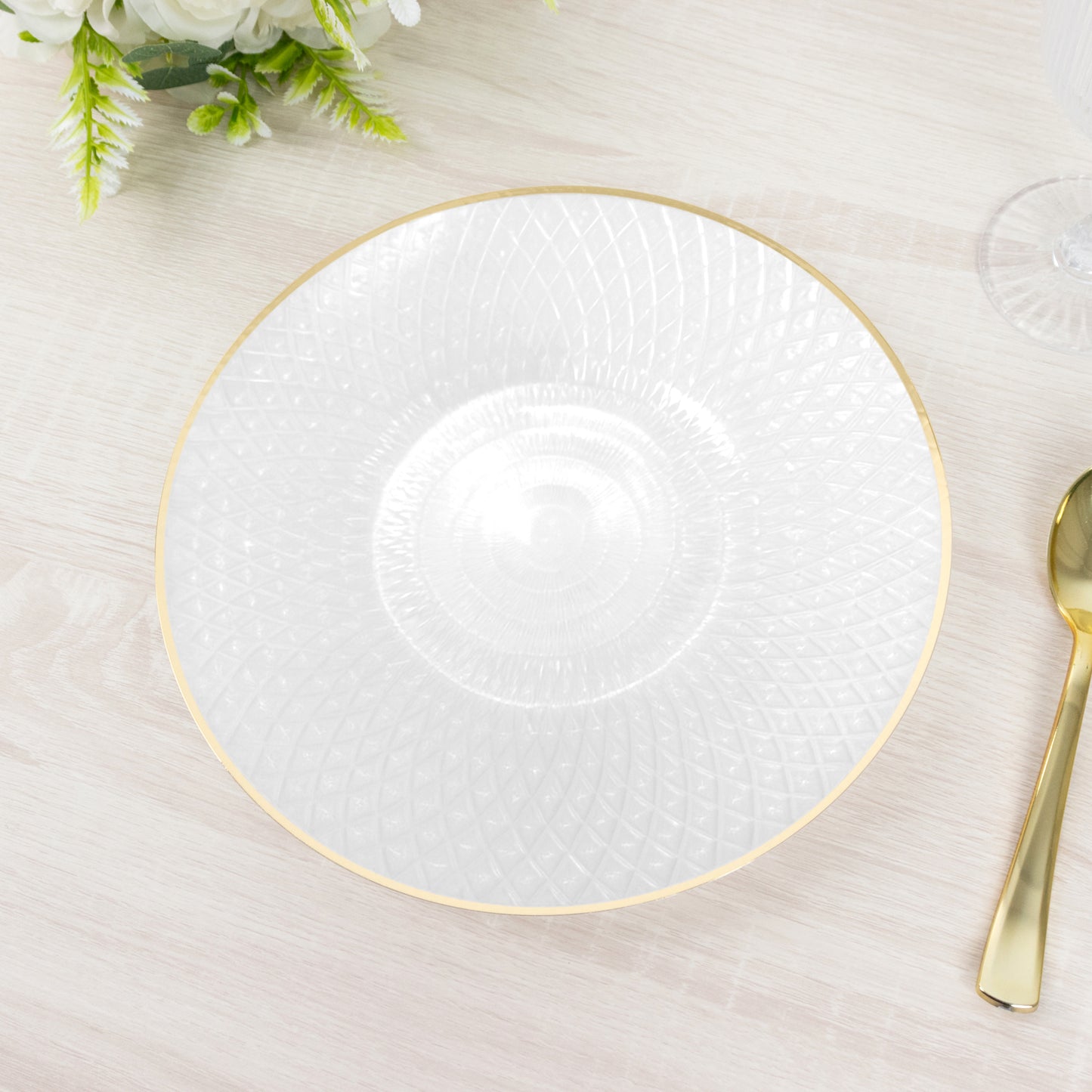 Pearl white plastic dinner plate with golden rim and diamond-cut pattern.