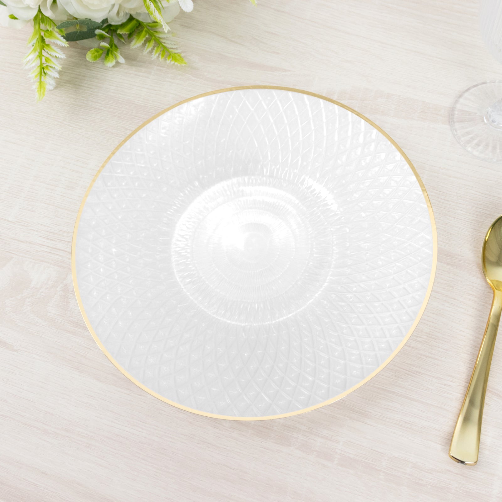 Pearl white plastic dinner plate with golden rim and diamond-cut pattern.