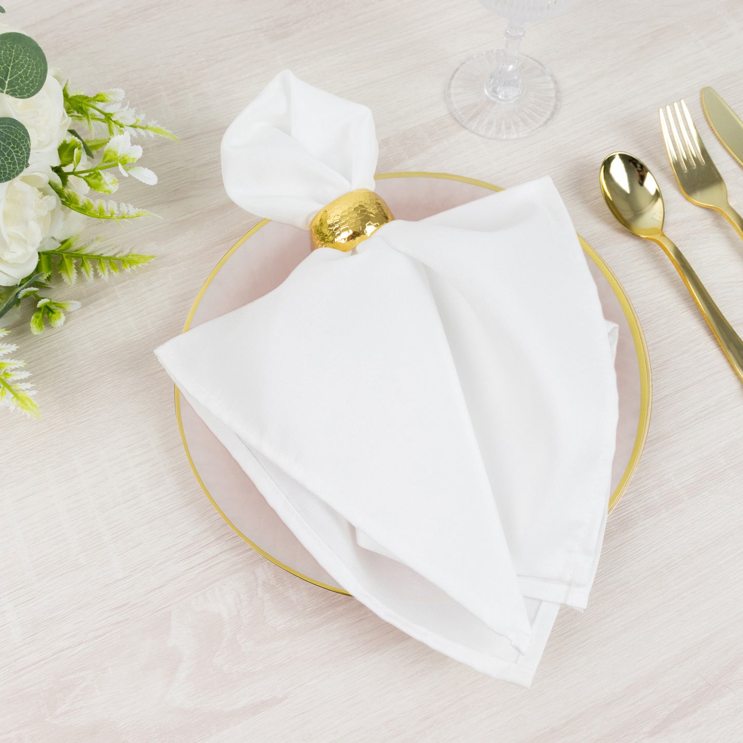 Blush plastic dessert plate with gold rim and diamond-cut pattern.