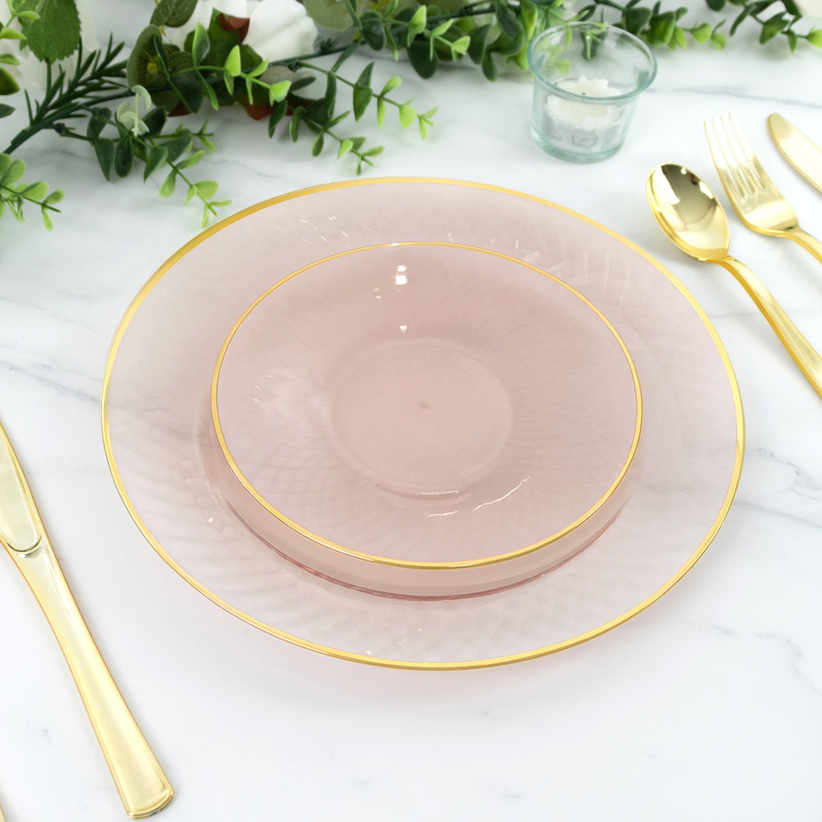 Blush pink dessert plates with gold rims and diamond-cut pattern.