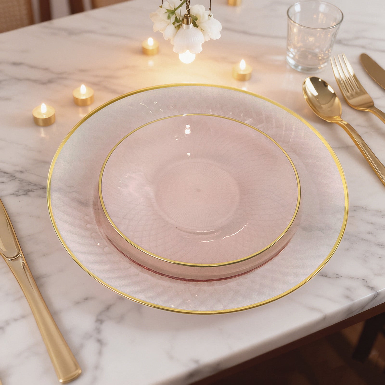 Blush pink round plastic dessert plates with gold rim, diamond-cut pattern.