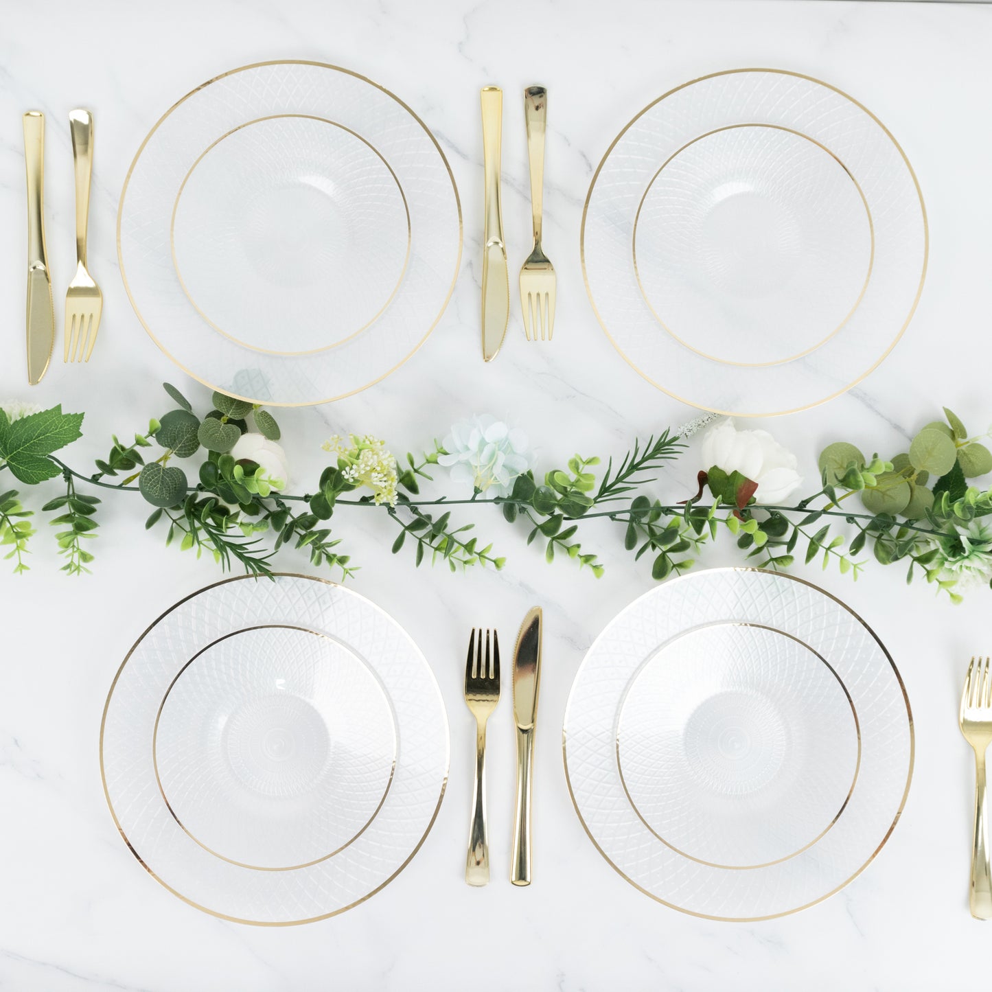 Round pearl white disposable dessert plates with gold rim on a table setting.