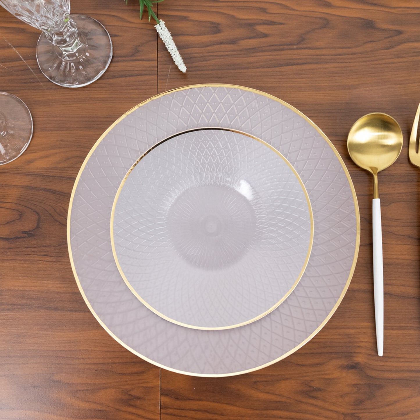 Pearl white disposable dessert plates with gold rim and diamond-cut pattern.