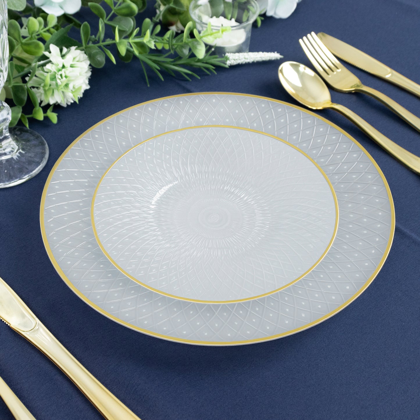 Pearl white round plastic dessert plate with gold rim and diamond-cut pattern.