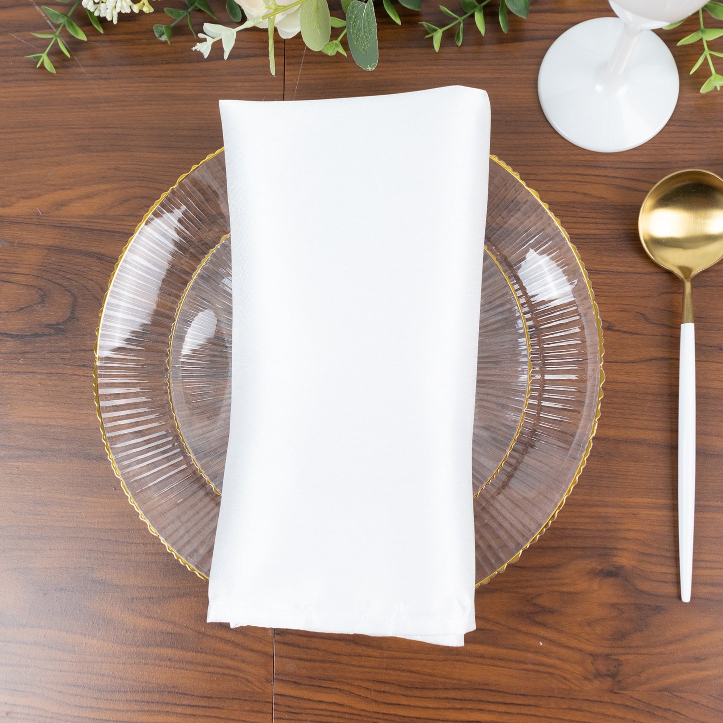 Clear plastic dessert plate with gold rim and ribbed sunburst pattern.