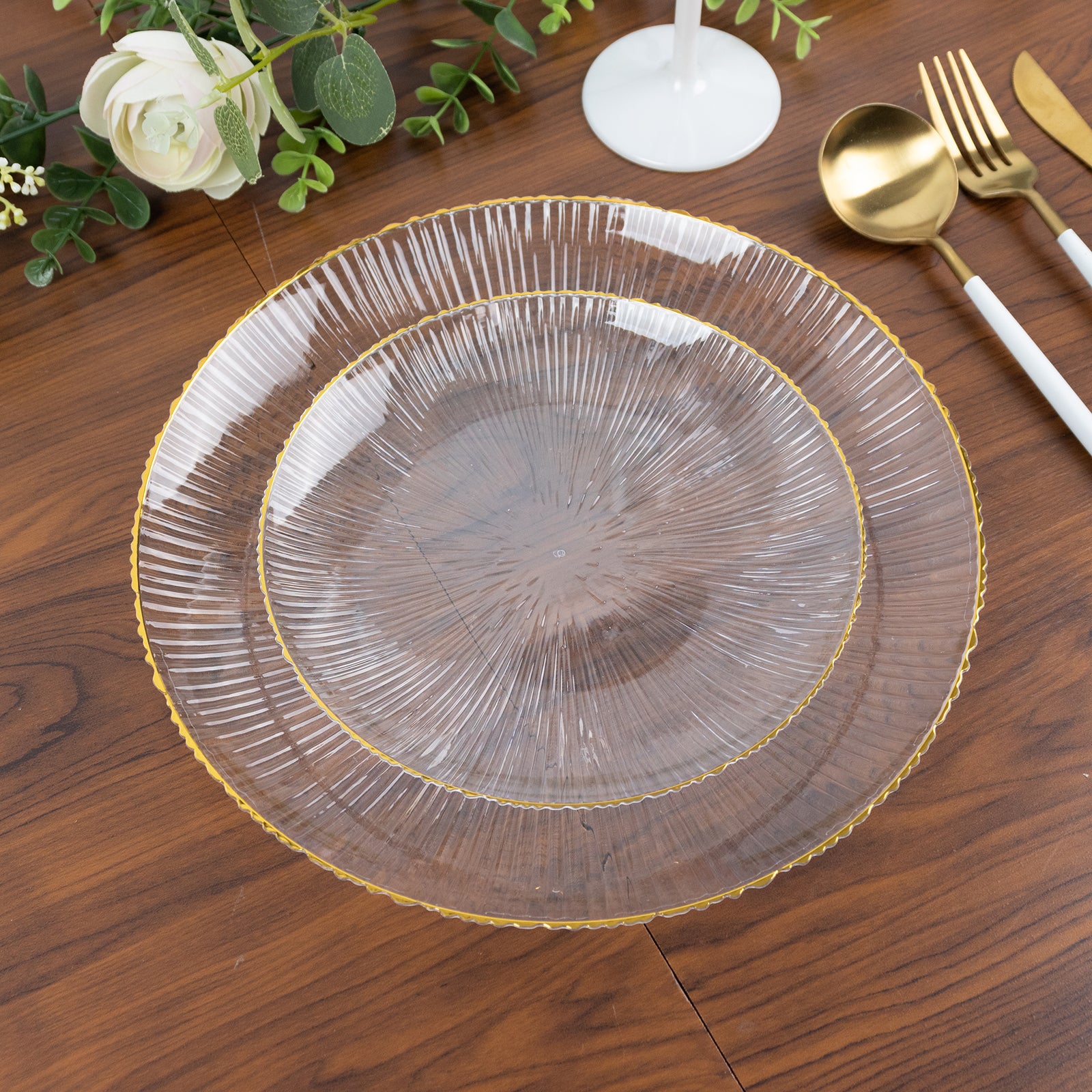 Clear plastic dessert plate with gold rim and ribbed sunburst pattern.