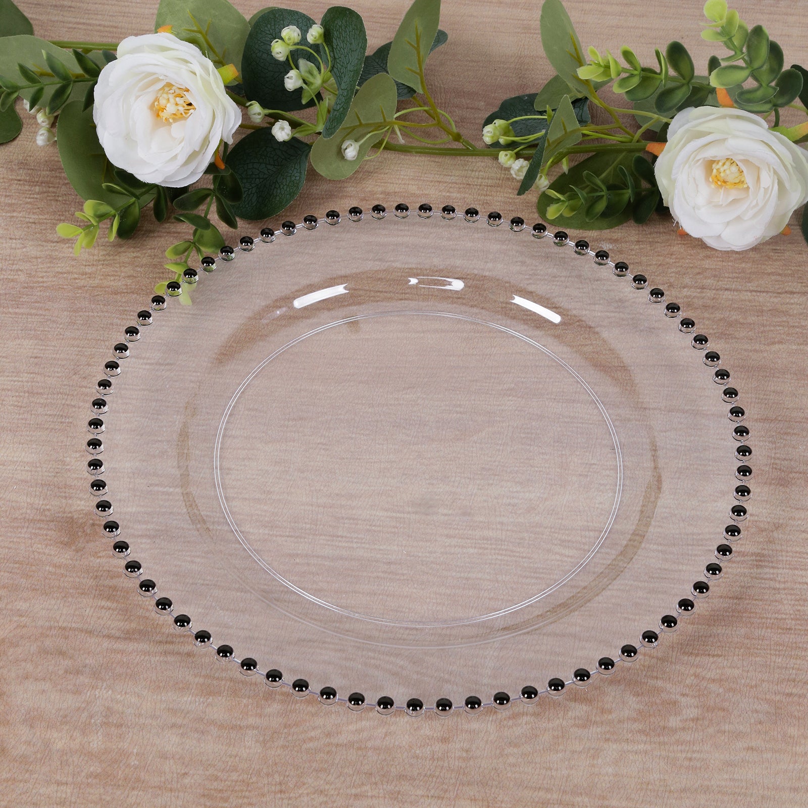 Clear round dinner plate with black beaded rim for festive occasions.
