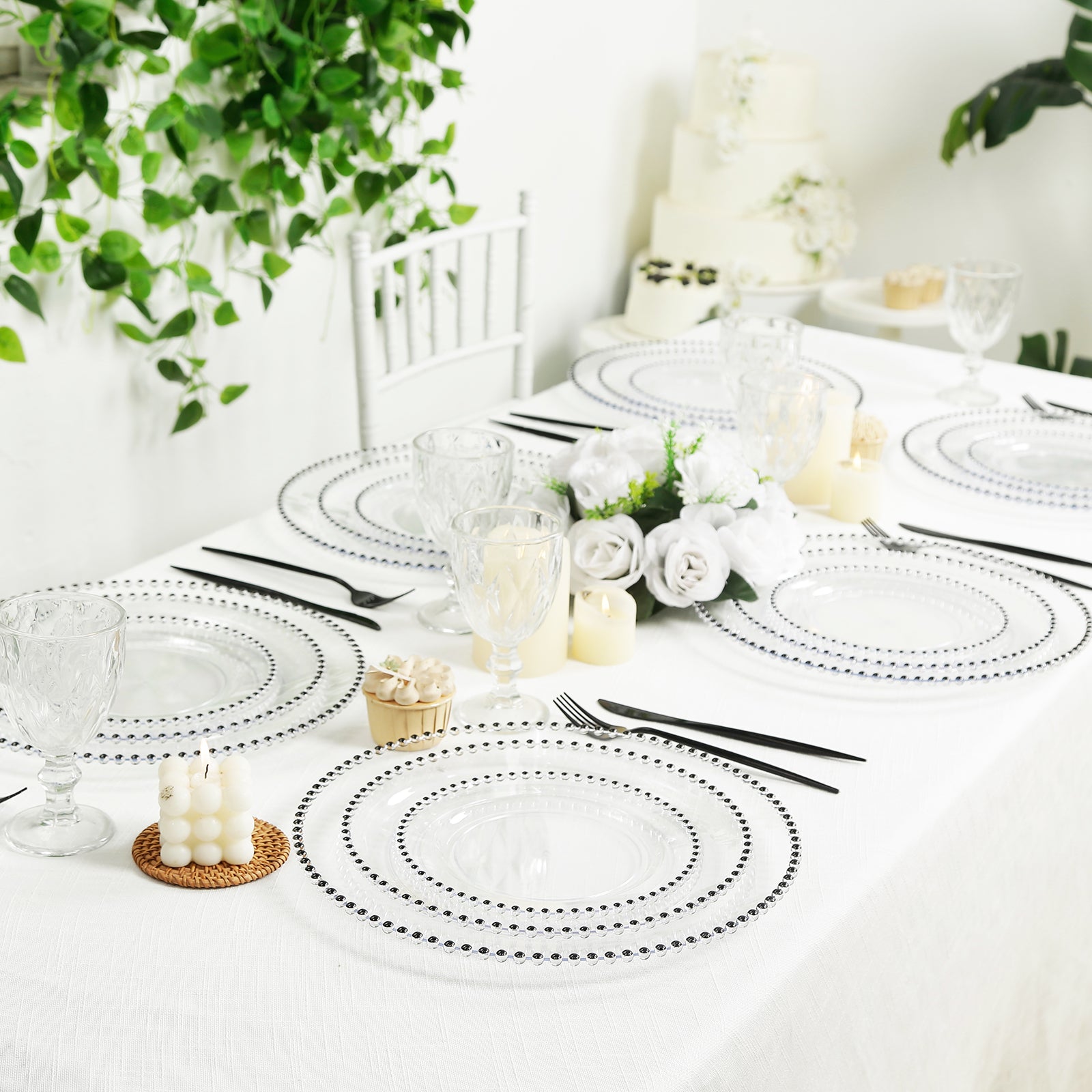 Clear plastic dessert plates with black beaded rim on a beautifully set table.