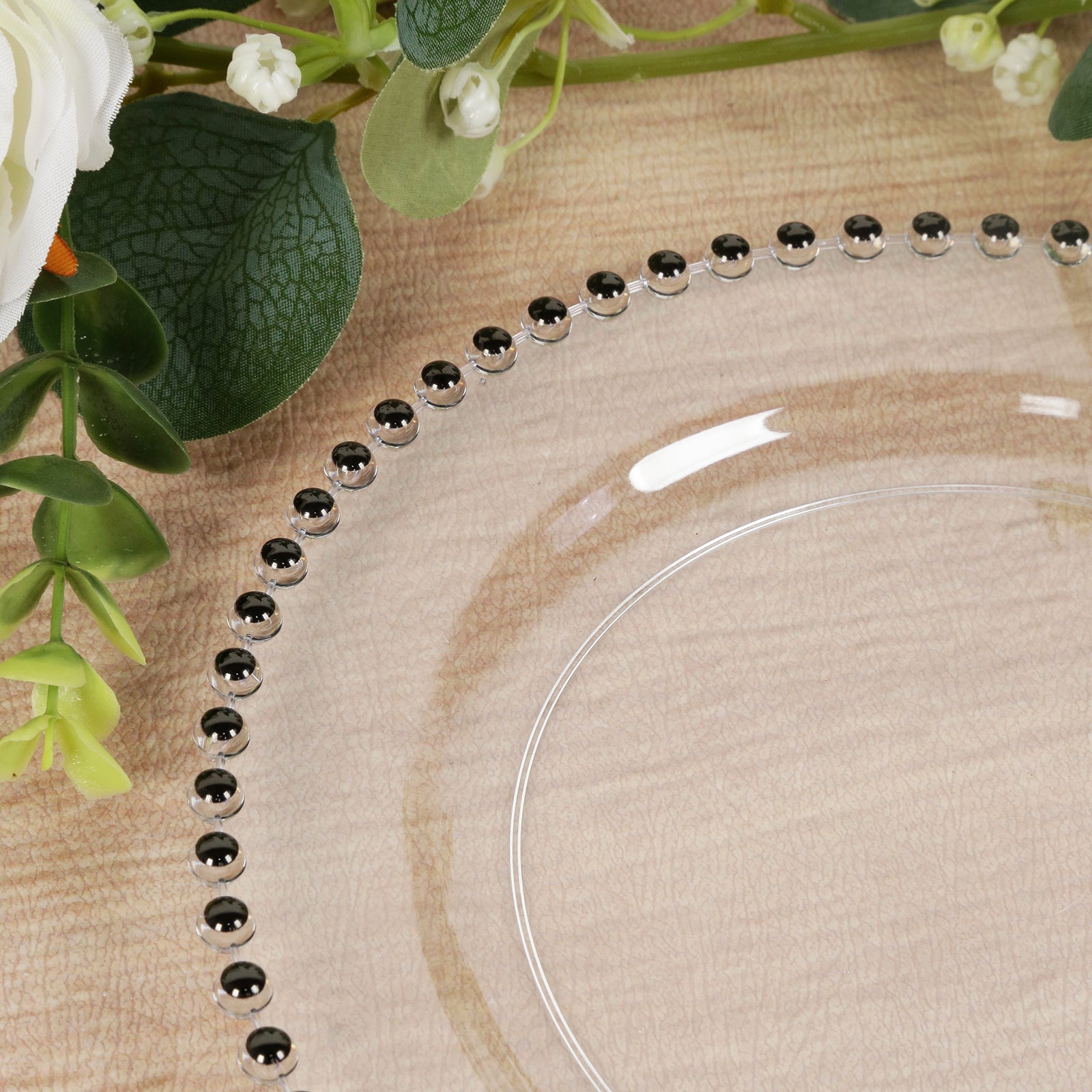 Clear plastic dessert plate with black beaded rim, perfect for parties.
