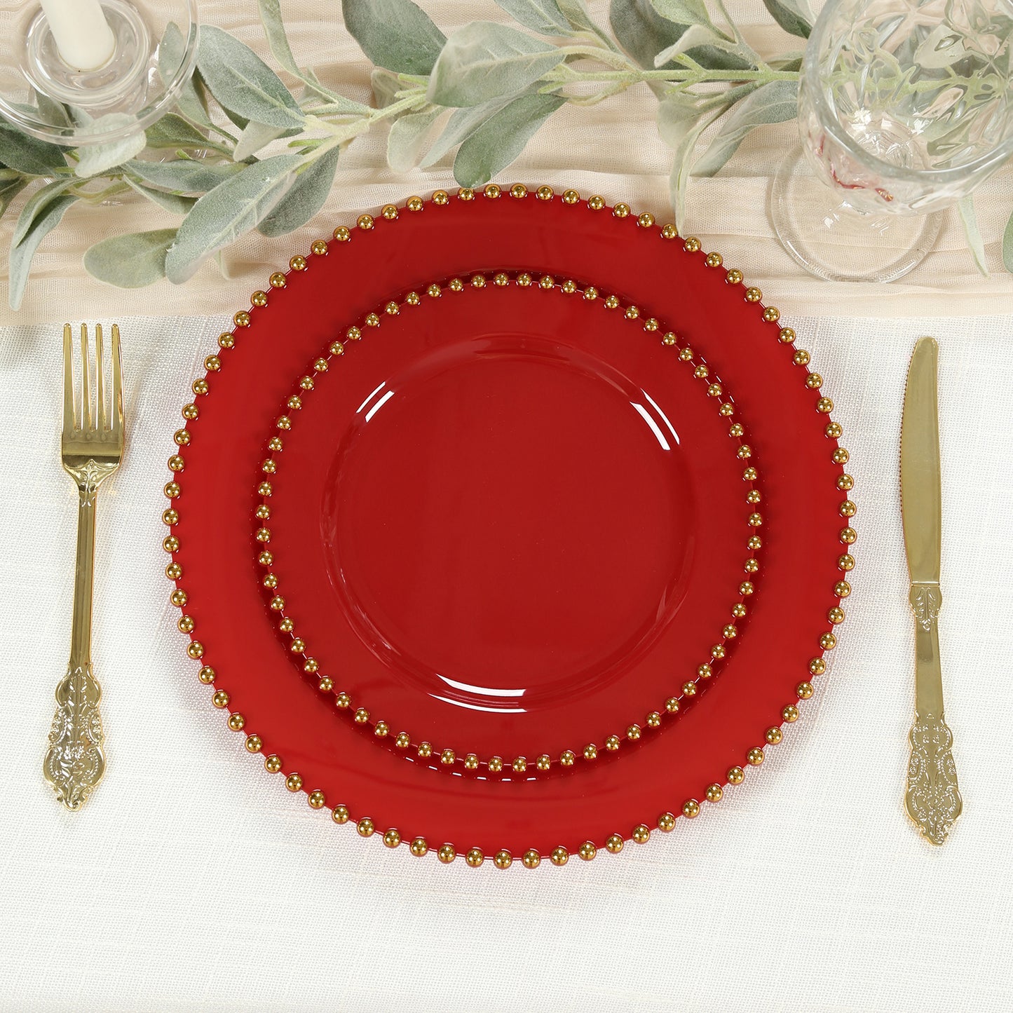Red plastic dessert plates with gold beaded rim, perfect for parties.