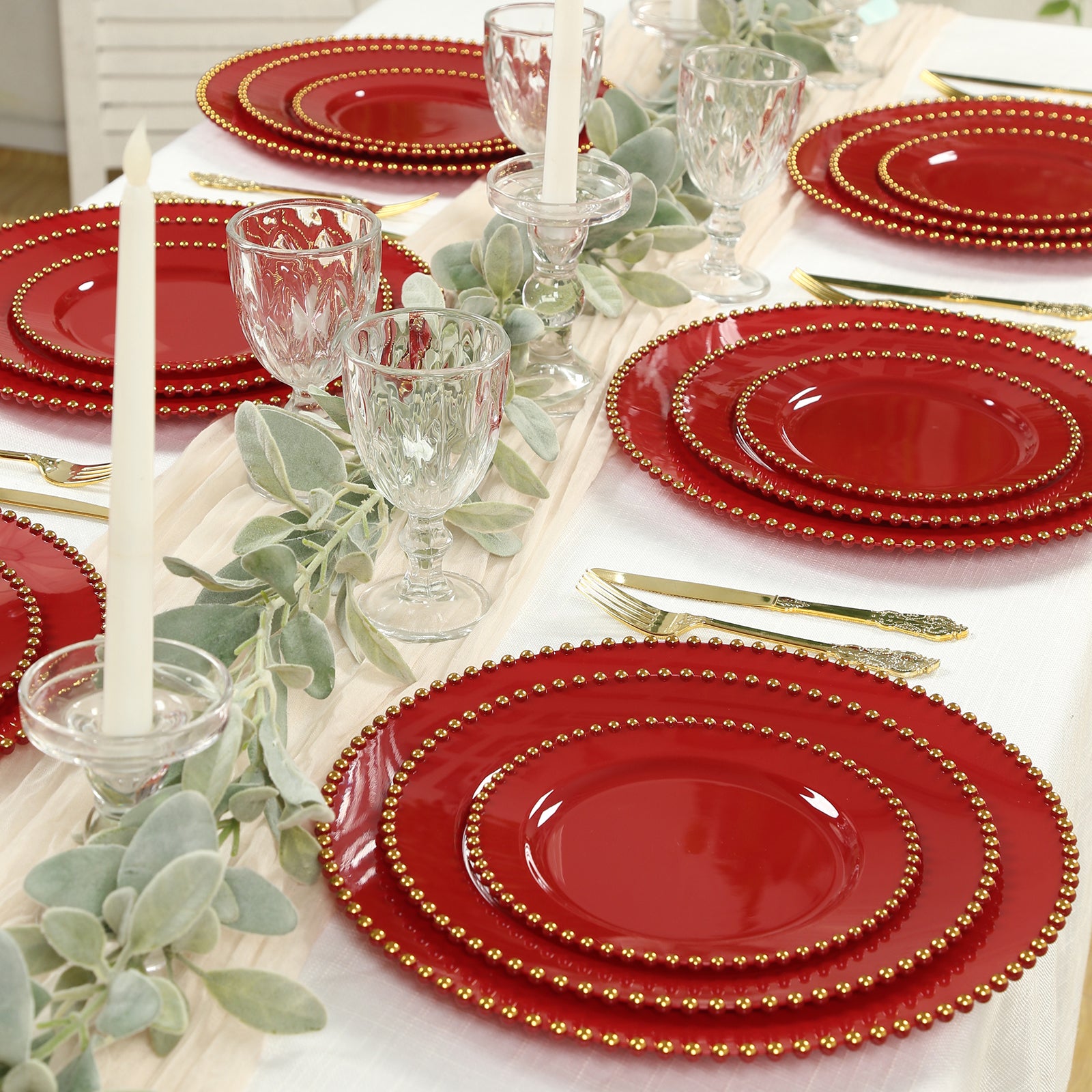 Red plastic dessert plates with gold beaded rim for parties and events.